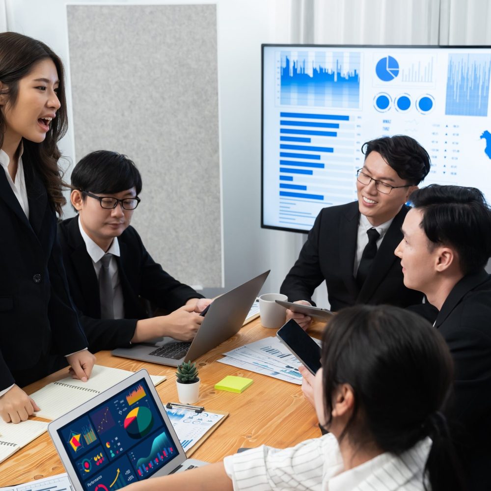 Business team of financial data analysis meeting with business intelligence, report paper and dashboard on laptop for marketing strategy. Business people working together to promote harmony in office.
